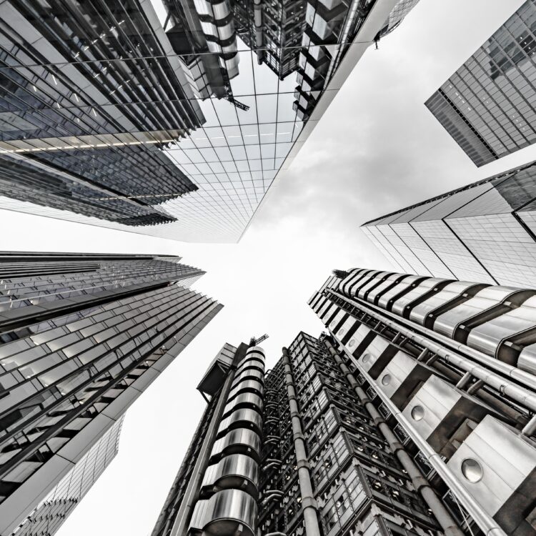 A vertical low angle shot of a modern business building scenery touching the sky